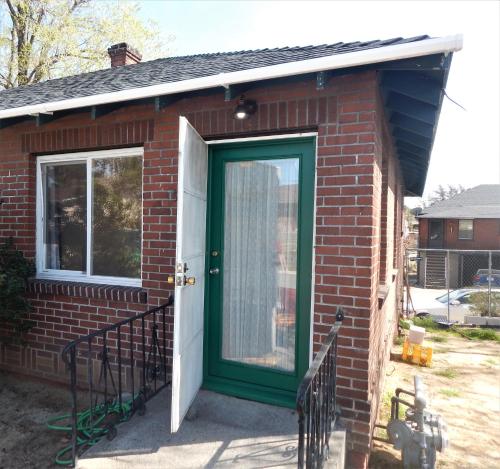 a red brick house with a green door at Midcentury Gem in Midtown Reno in Reno