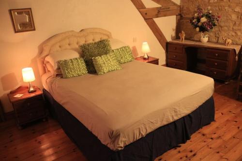 a bedroom with a large bed with two night stands at Another Day in Paradise in Lizant