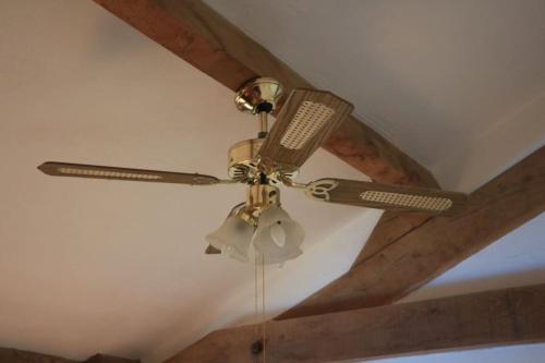 a ceiling fan sitting on top of a ceiling at Another Day in Paradise in Lizant