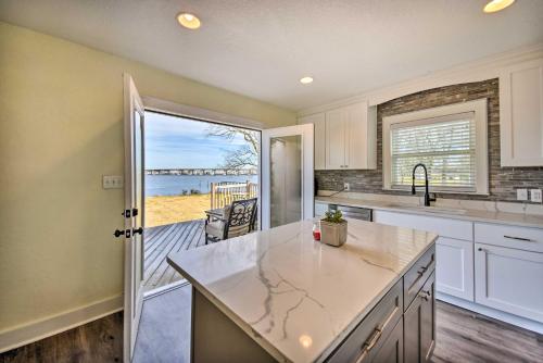 a kitchen with a counter and a view of the ocean at Portsmouth Waterfront Vacation Rental with Deck in Portsmouth