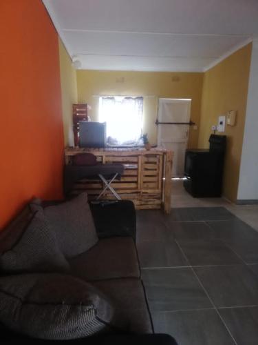a living room with a couch and a kitchen at Dream villa in Otse