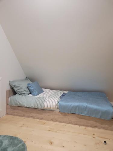 a bed with blue pillows on it in a room at Villa Ema in Pale