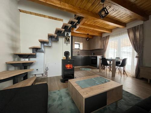 a living room with a staircase and a stove at Villa Ema in Pale