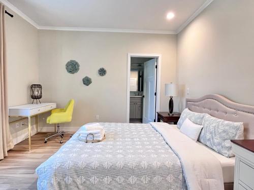 a bedroom with a bed with a desk and a yellow chair at Luxury 2BR Minutes from Old Town Pasadena in Pasadena