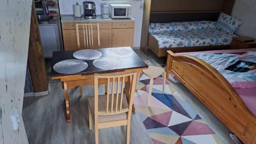 a small kitchen with a table and a bed at Casa Luna in Gura Humorului
