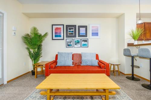 a living room with a red couch and a table at Harmony Hills #229 in Anchorage