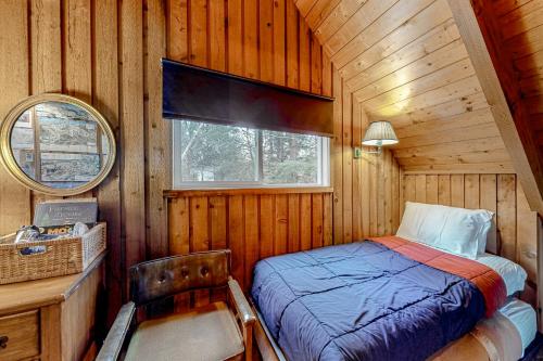 a bedroom with a bed in a wooden cabin at Mowing Way Retreat in Wilmington
