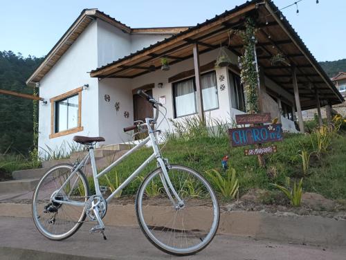a bike parked in front of a house at La Casita de Charo 2 in Constanza