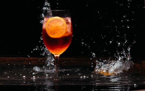 a drink with an orange slice in the water at Casa Azulai Puebla Hotel Boutique in Puebla