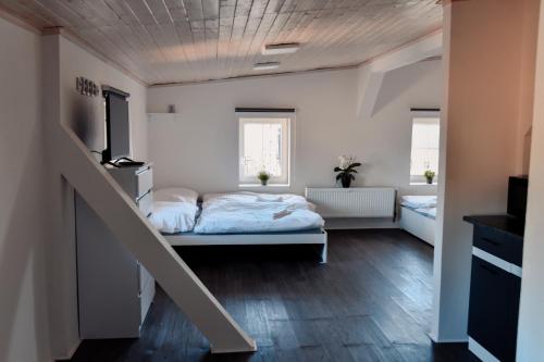 a bedroom with a bed and a staircase in it at Apartmány Centrum in Nový Bor