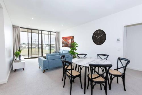 a living room with a table and chairs and a couch at Trendy, Self Contained Inner City Apartment!! in Wagga Wagga