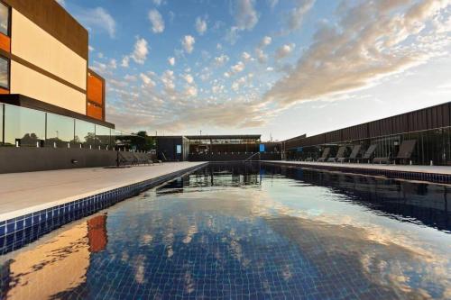 a large swimming pool in front of a building at Trendy, Self Contained Inner City Apartment!! in Wagga Wagga