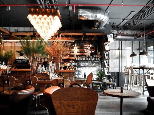 a restaurant with tables and chairs in a room at Trendy, Self Contained Inner City Apartment!! in Wagga Wagga