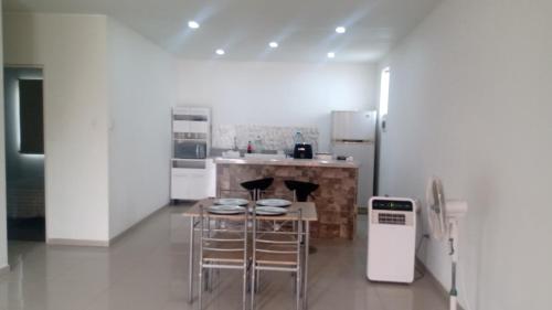 a kitchen with a table and chairs and a refrigerator at Casa en cineguilla in Cieneguilla