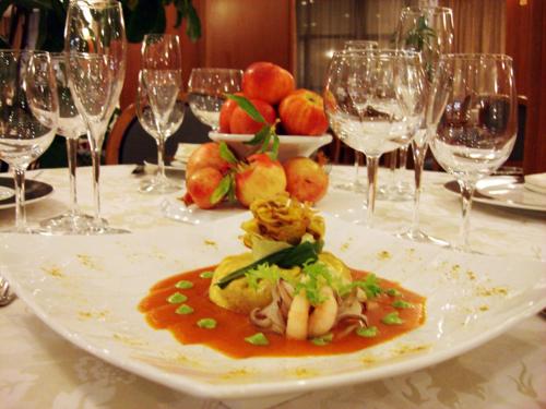 a plate of food on a table with wine glasses at Park Hotel Ristorante Ca' Bianca in Istrana
