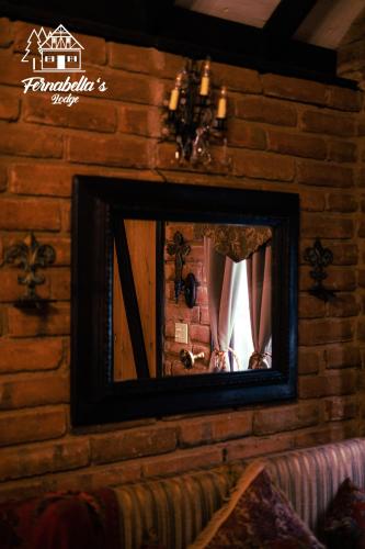 a mirror on a brick wall in a room at Fernabella's Lodge in Valle de Guadalupe