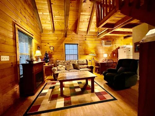 a living room with a couch and a table at Good Life Cabin 1 in Bryson City