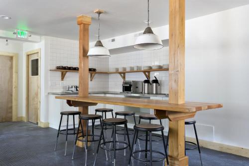 a kitchen with a wooden counter and stools at The Coachman Hotel in South Lake Tahoe