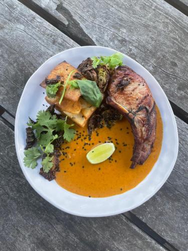 a plate of food on a wooden table at Harrietville Hotel Motel in Harrietville