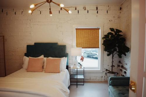 a bedroom with a bed and a window at The Oleander Hotel Room Number 1 in Galveston