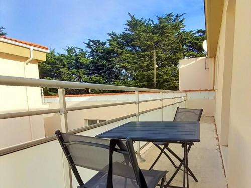 une table bleue et deux chaises sur un balcon dans l'établissement Appartement NEUF 1 chambre, 4 pers, 350m plage Saint Jean de Monts, calme, forêt, commerces à proximité - FR-1-323-268, à Saint-Jean-de-Monts