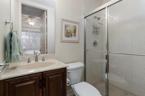 a bathroom with a toilet sink and a shower at -The Bonita Paddle Efficiency- Your Home Away From Home in Paradise condo in Bonita Springs