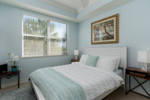 a bedroom with a white bed and a window at - The Bonita Paddle A202 - Beautiful Bonita Springs Condo with Mother In Law Suite! condo in Bonita Springs