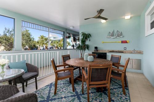 a dining room with a table and chairs and a balcony at -The Bonita Paddle 2 2- Your Home Away From Home in Paradise condo in Bonita Springs