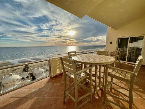 a balcony with a table and chairs and the ocean at Spectacular 2 Bedroom Condo on Sandy Beach at Las Palmas Resort B-705 condo in Puerto Peñasco