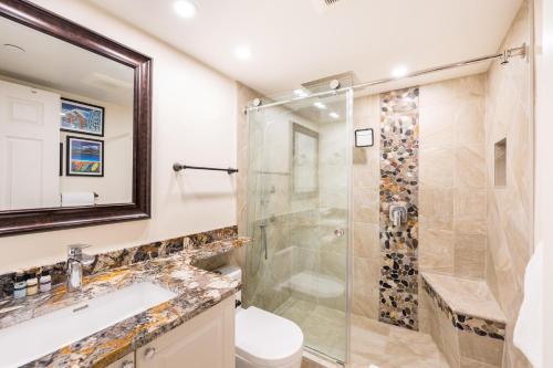 a bathroom with a shower and a toilet and a sink at 116 Aspens in Whistler