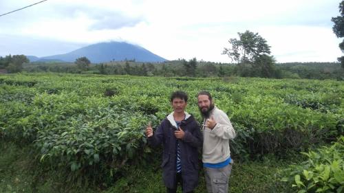 a man and a woman standing in a field at Nyang Ebay Surf Camp Siberut in Masokut