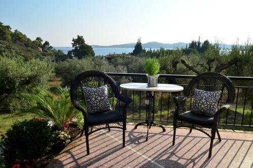 two chairs and a table on a balcony at Philippos 1 in Diaporos