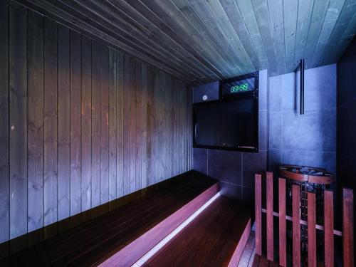 a small room with a tv on the wall at Tabist THE GREEN OTARU in Otaru