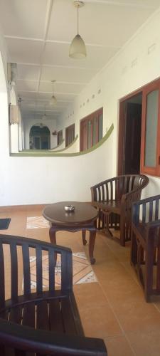 a room with two tables and chairs and a mirror at Ocean View tourist guest house at Negombo beach near the airport in Negombo