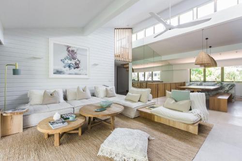 a living room with a couch and a table at Little Cove Treetops Little Cove Magic in Noosa Heads