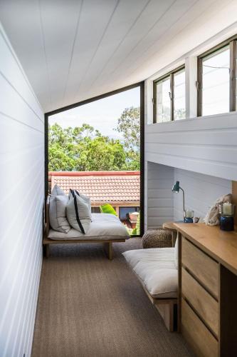 a room with two beds and a window at Little Cove Treetops Little Cove Magic in Noosa Heads