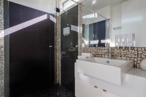 a bathroom with a white sink and a shower at Bass Vista in Cape Schanck