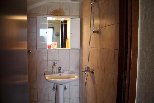 a bathroom with a sink and a mirror at Miranta in Nikiti