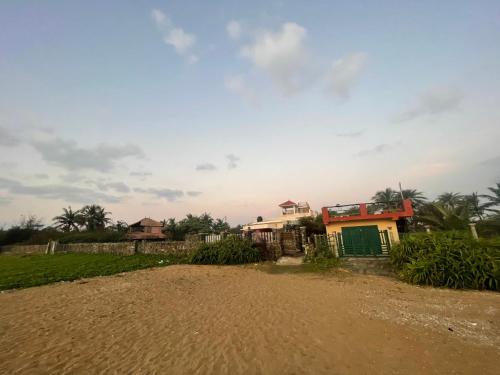 a house on the side of a dirt road at Coral Drive Villas -Your Private Beach Destination in Chennai