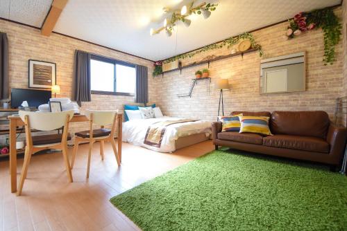a bedroom with a bed and a couch and a table at Comfy Stay MR1 & MR2 in Nara
