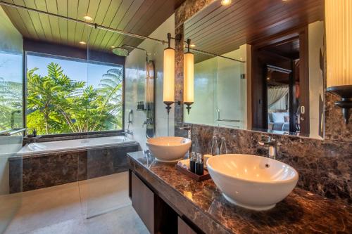 two sinks in a bathroom with a large window at HOMM Saranam Baturiti, Bali in Bedugul