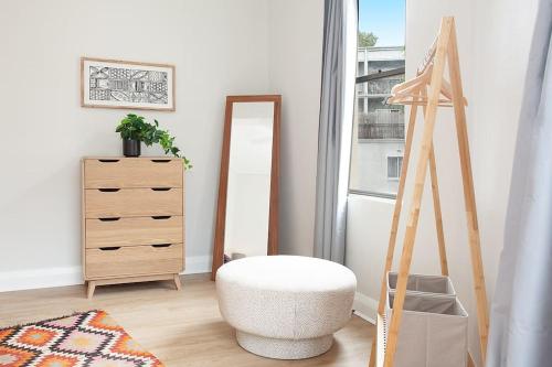 a dressing room with a stool and a mirror at Large 4 Bed Beachside Haven 50m to Bondi Beach in Sydney
