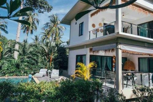 a house with a pool and palm trees at AFRICA 3br VILLA NEAR THE BEACH in Mae Haad