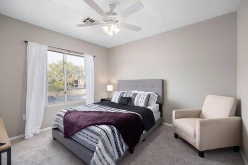 a bedroom with a bed and a chair and a window at Amazing Villa Close To Airport in Phoenix