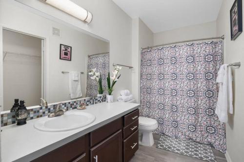 a bathroom with a sink and a toilet and a shower at Amazing Villa Close To Airport in Phoenix