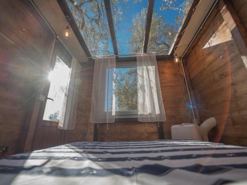 a bedroom with a large window and a bed at Agriturismo S.Ilario in Genova