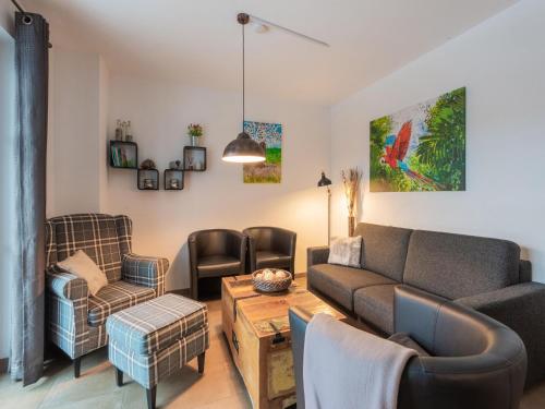 a living room with a couch and chairs at Modern Apartment in Brixen im Thale near Ski Area in Feuring