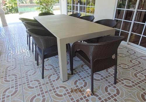 a white table and chairs on a floor at Hutiarii house & car & excursions Raiatea in Tevaitoa
