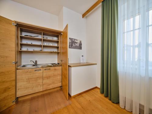 a kitchen with a sink and a cabinet with a window at Hofwirthotel in Sankt Martin im Innkreis