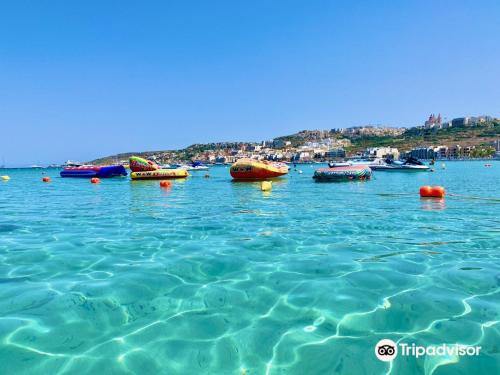 a group of boats sitting in the water at Seafront Apartment in St. Paul's Bay in St Paul's Bay